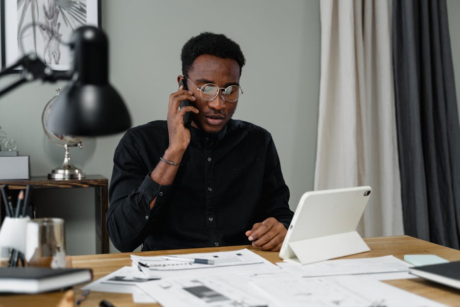 A person reviewing a proposal on a tablet with business documents scattered around - digital marketing agency
